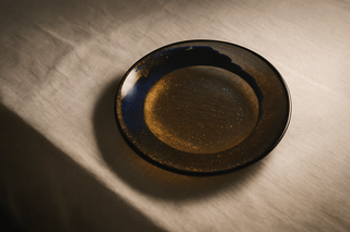Fused glass tableware set in deep blue and amber tones