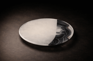 Handmade fused glass plate with translucent and dark layered surface