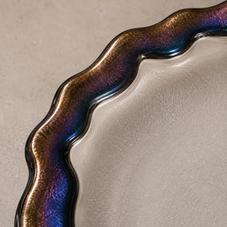 Close-up of the Obsidian Veil fused glass plate rim with rainbow iridescence, blue, violet, and bronze reflections.